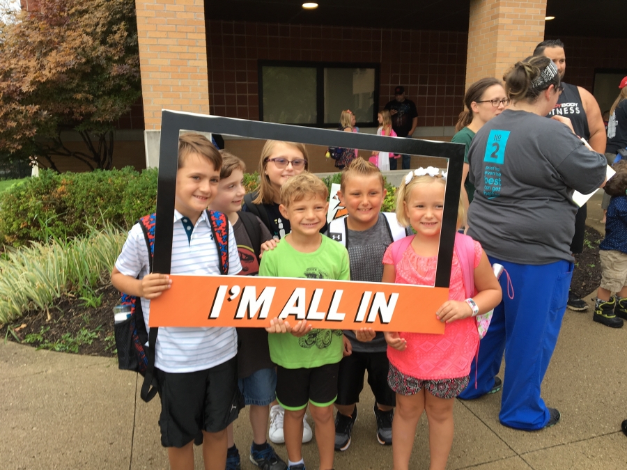 people holding a frame sign